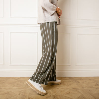 Model wearing the khaki green Pinstripe Linen Trousers in Small/Medium